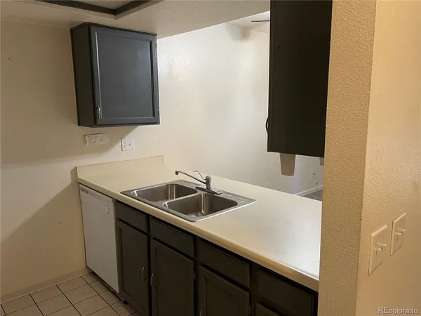 a kitchen with a sink and a mirror