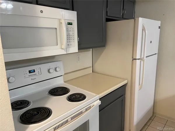 a kitchen with a stove and a refrigerator