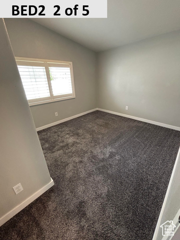 335 Memorial Park Road Henefer, UT 84033 - Photo 16 of 51 Bedroom 2 with dark colored carpet and vaulted ceiling
