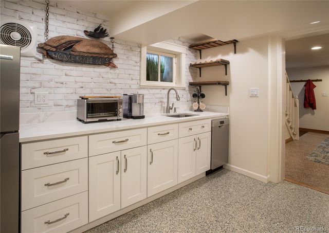 a kitchen with cabinets stainless steel appliances and a counter space