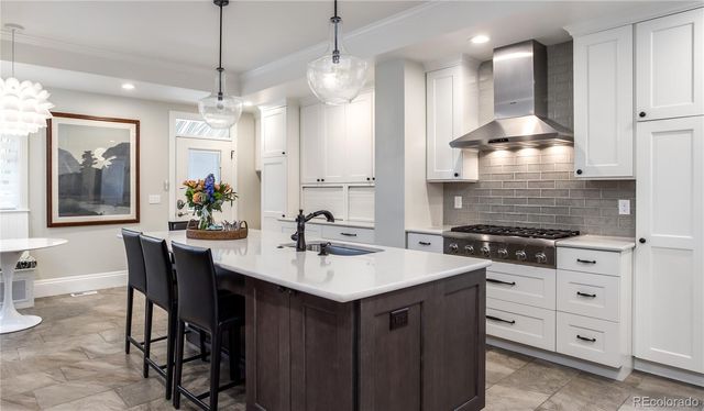 a kitchen with stainless steel appliances a sink stove and refrigerator
