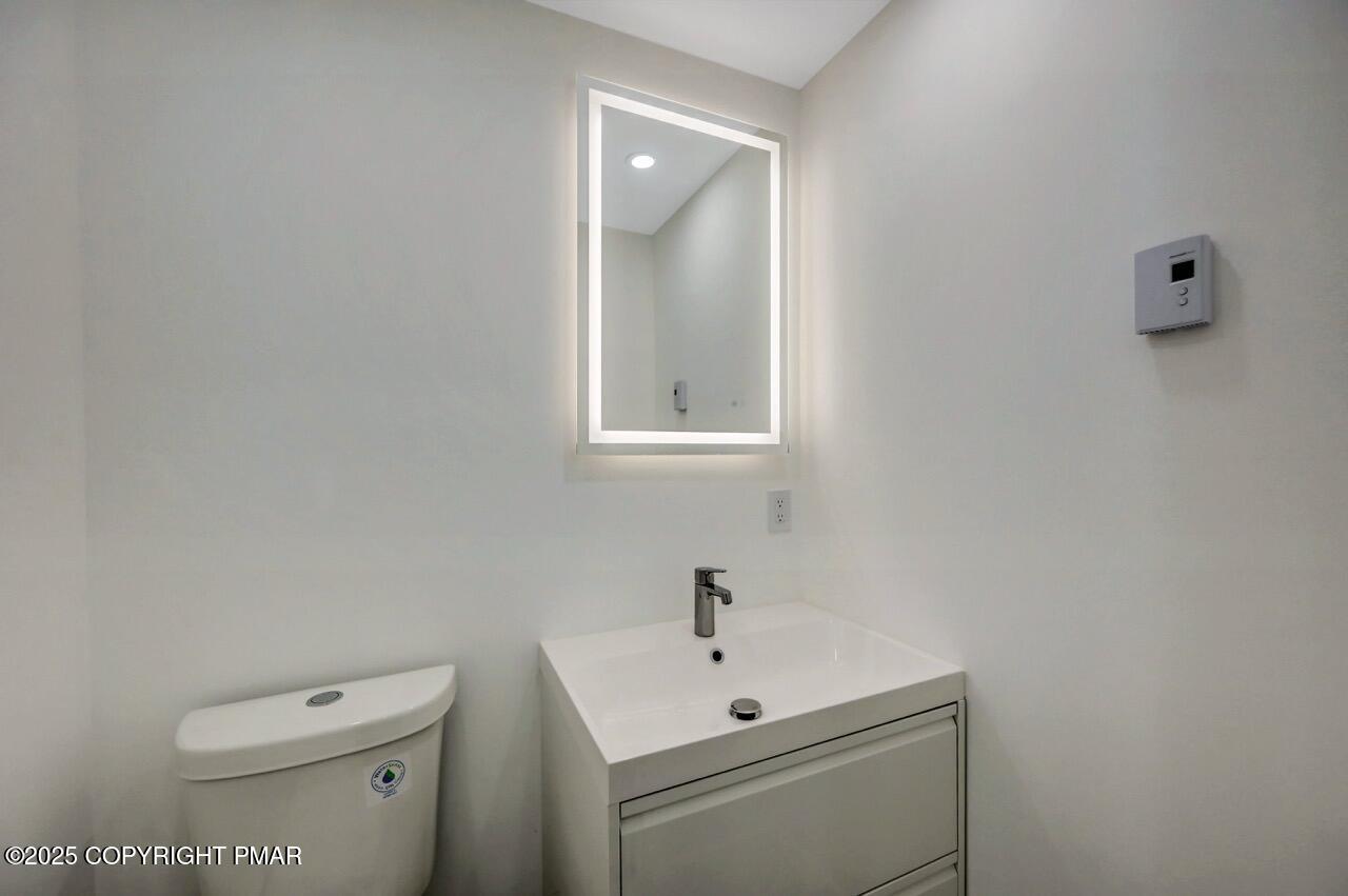 752 Toll Road Effort, PA 18330 - Photo 27 of 101 a bathroom with a toilet a sink and mirror