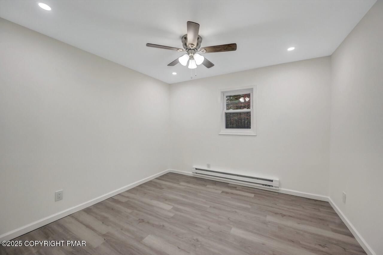 752 Toll Road Effort, PA 18330 - Photo 37 of 101 an empty room with a window and ceiling fan