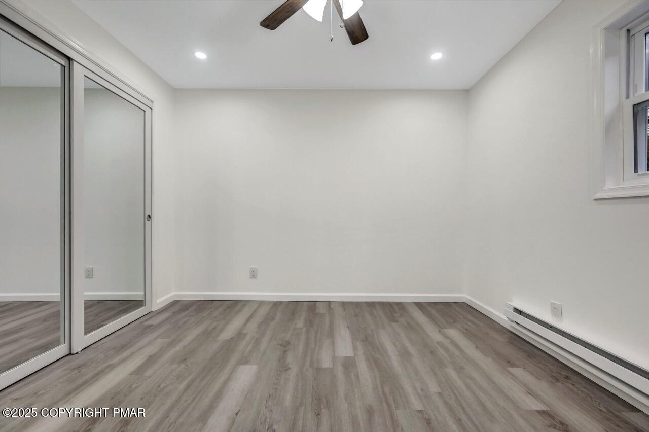 752 Toll Road Effort, PA 18330 - Photo 40 of 101 an empty room with wooden floor and windows