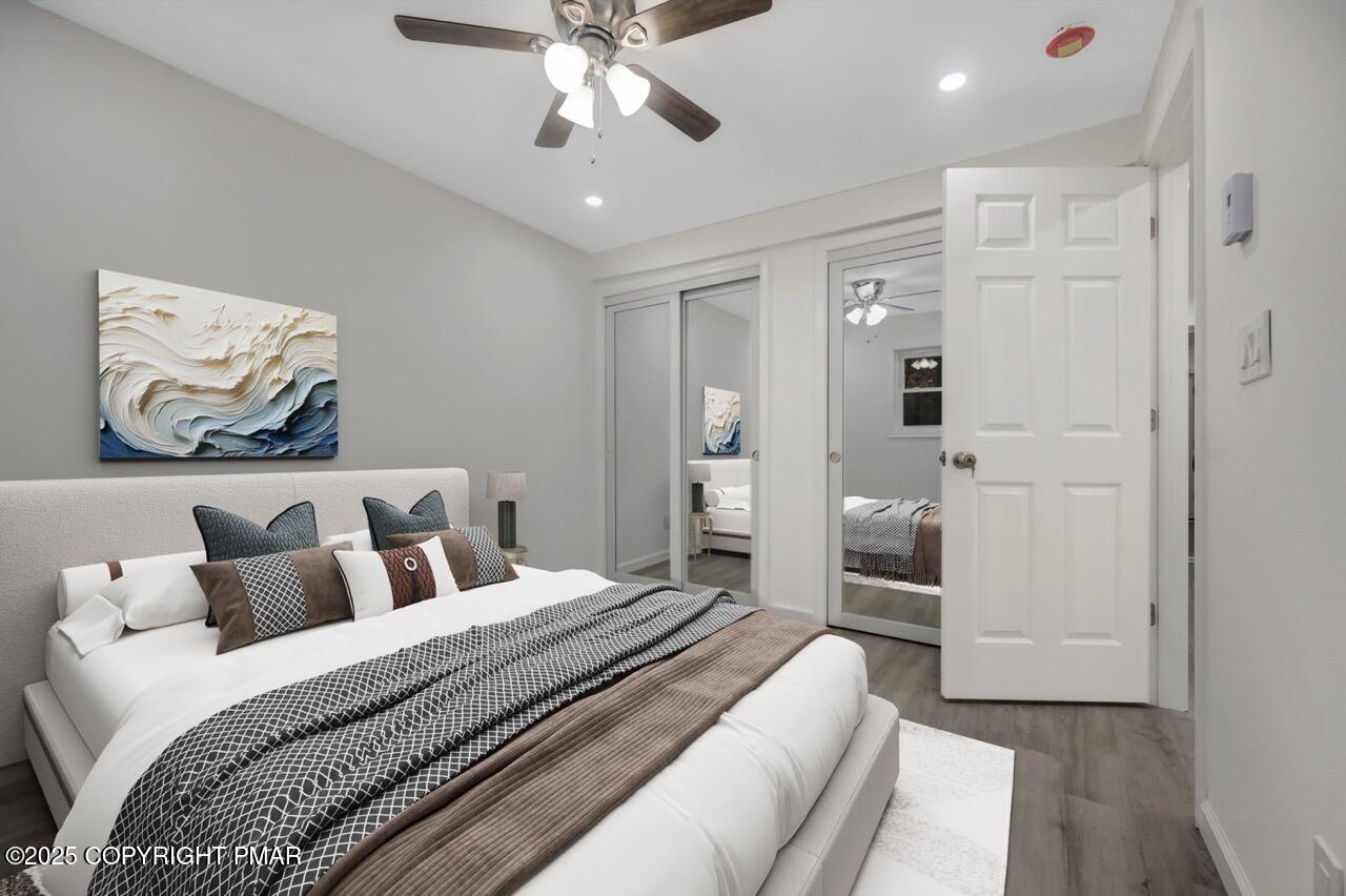 752 Toll Road Effort, PA 18330 - Photo 55 of 101 a bedroom with a large bed and a chandelier