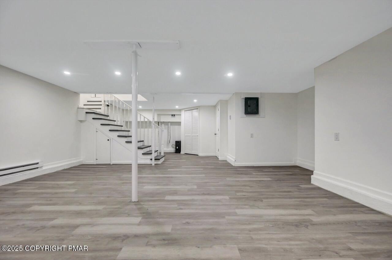 752 Toll Road Effort, PA 18330 - Photo 64 of 101 an empty room with wooden floor and chandelier