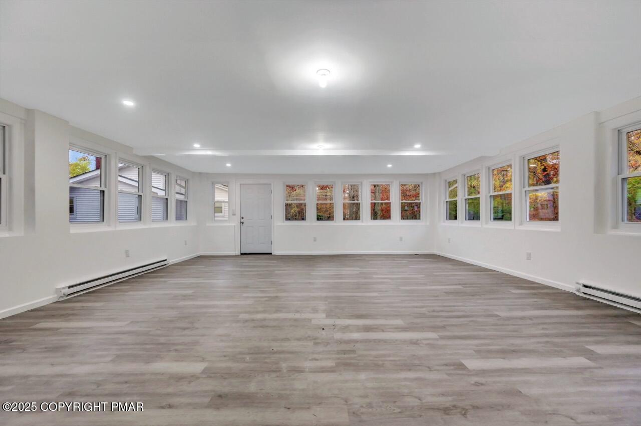 752 Toll Road Effort, PA 18330 - Photo 72 of 101 a view of an empty room with wooden floor and a window