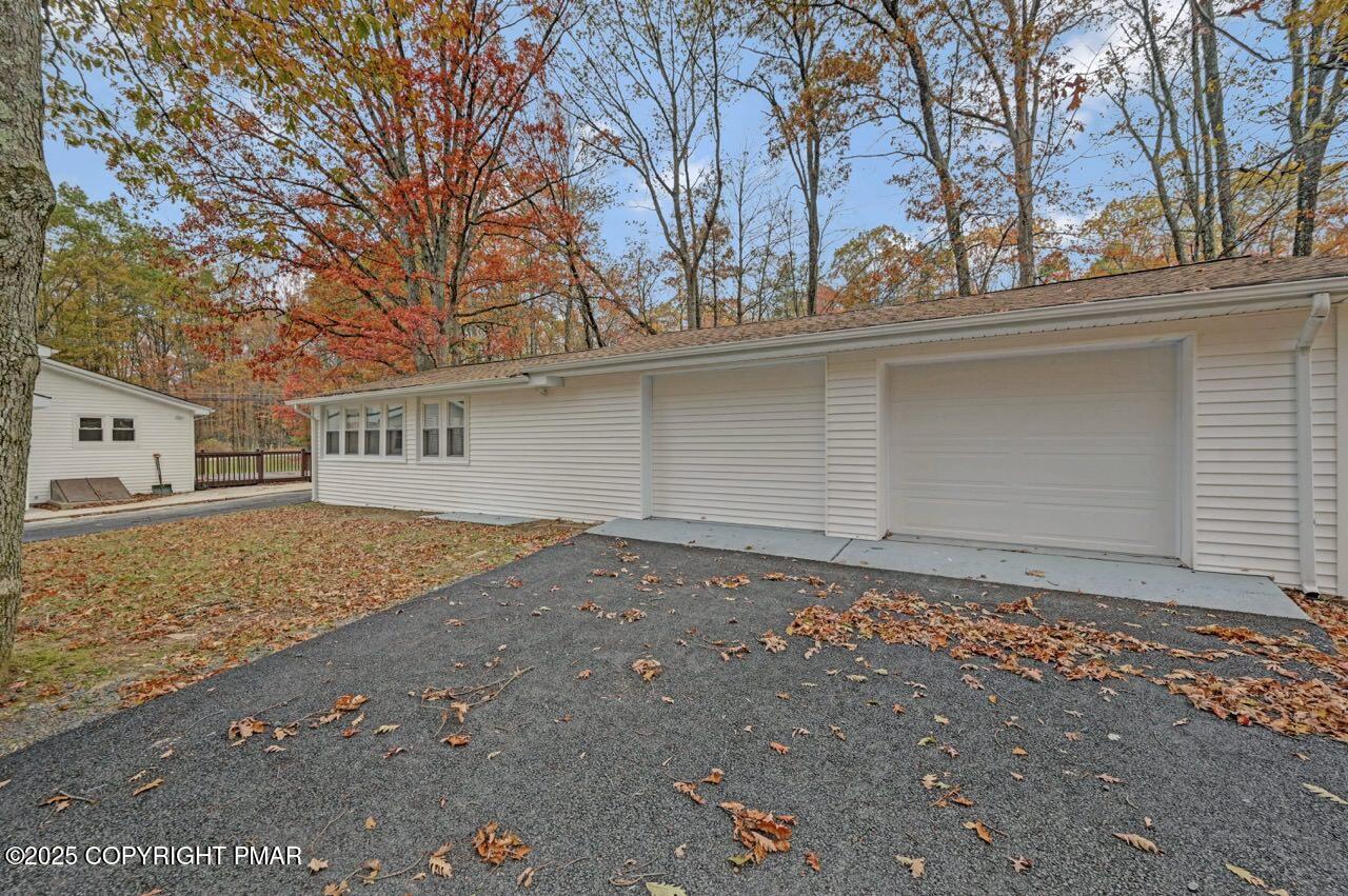 752 Toll Road Effort, PA 18330 - Photo 89 of 101 a backyard of a house with large trees and garage