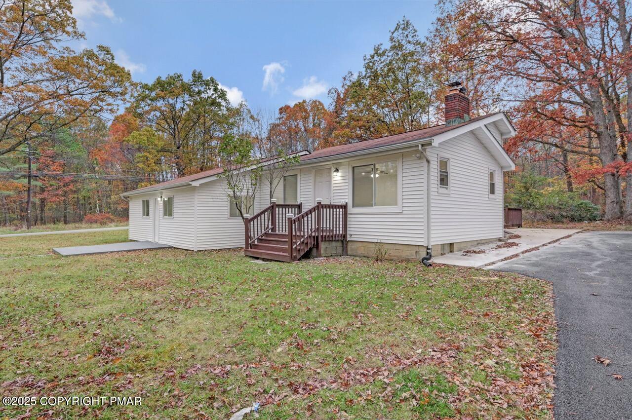 752 Toll Road Effort, PA 18330 - Photo 97 of 101 a view of backyard of house with outdoor seating and covered with trees