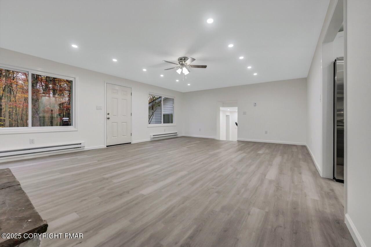 752 Toll Road Effort, PA 18330 - Photo 10 of 101 an empty room with wooden floor and windows
