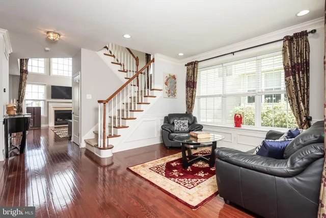 a living room with furniture and a large window or wooden floor