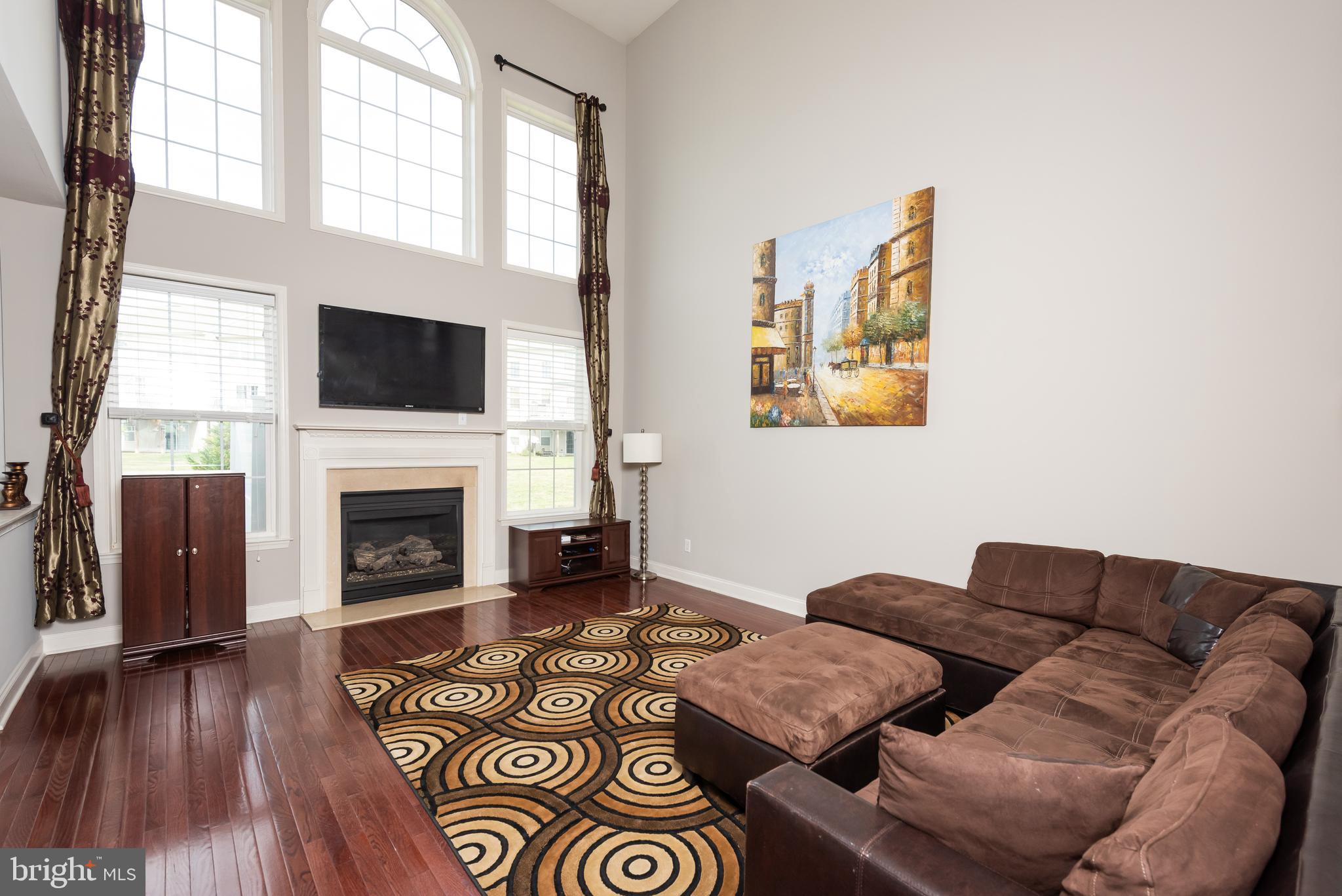 2604 Rockledge Court Chester Springs, PA 19425 - Photo 16 of 44 a living room with furniture a fireplace and a flat screen tv