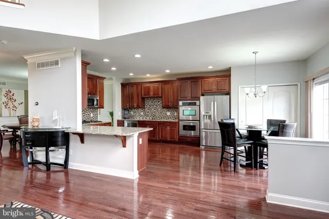 a kitchen with lots of counter top space and furniture