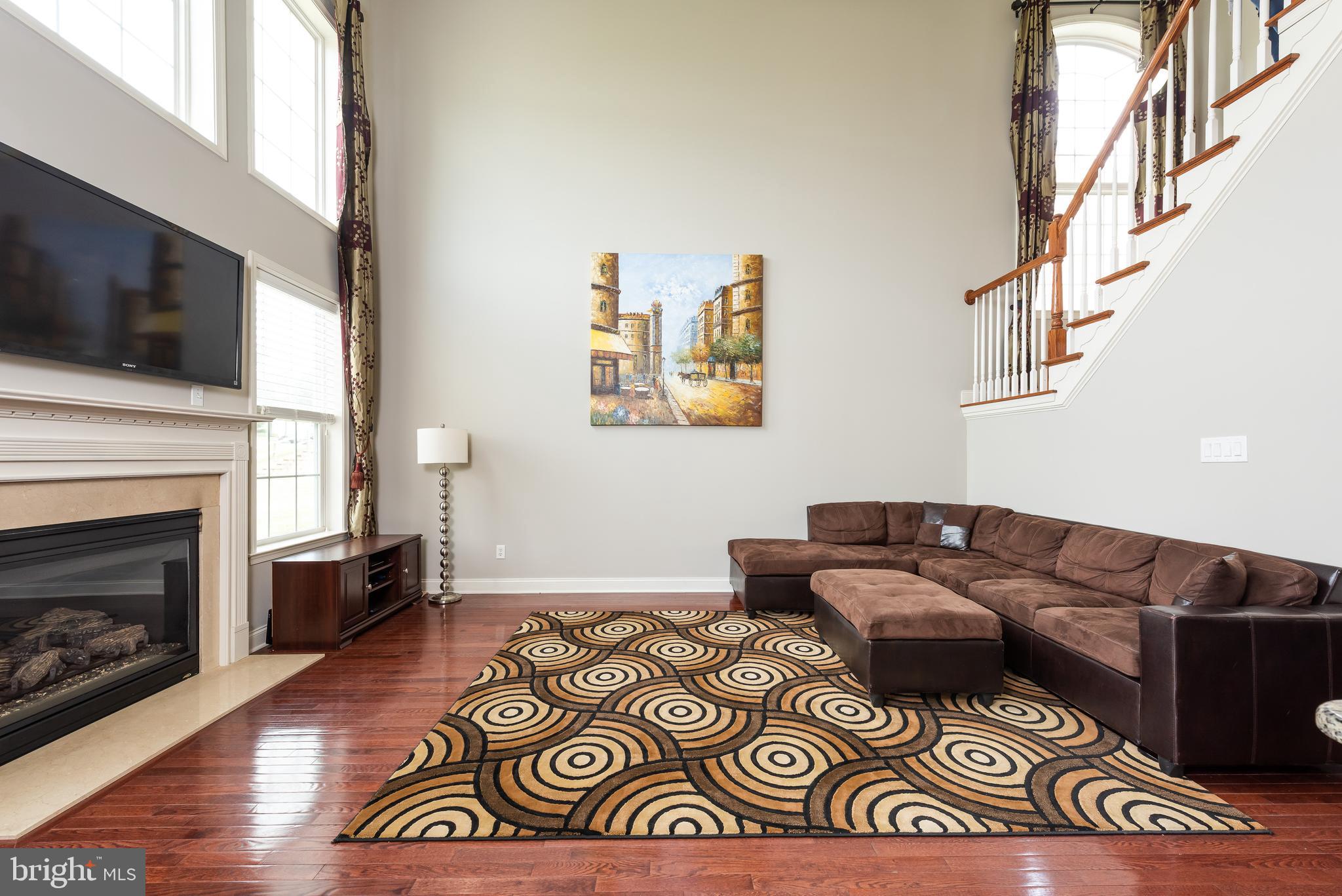 2604 Rockledge Court Chester Springs, PA 19425 - Photo 30 of 44 a living room with furniture a flat screen tv and a fireplace