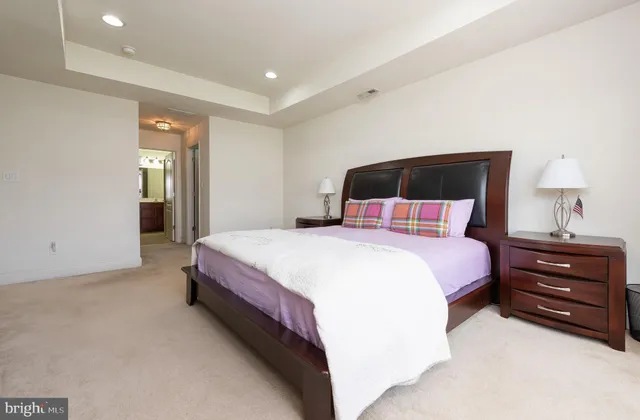 a bedroom with a bed and a lamp