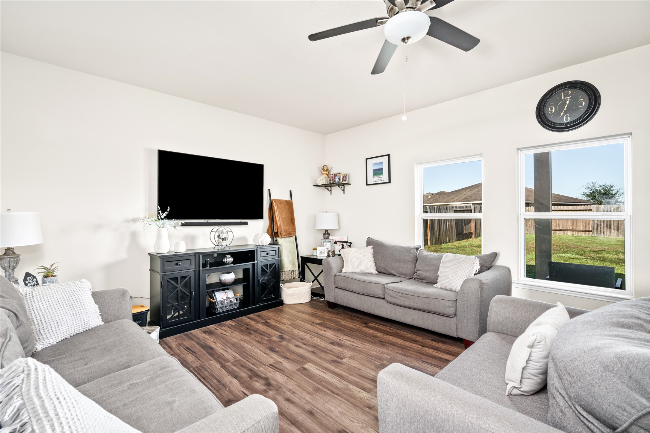 2011 Beach Bluff Road Rosenberg, TX 77469 - Photo 2 of 34 A bright and airy living room with wide windows invites natural light to flood the space, creating a warm and open atmosphere. The expansive windows offer stunning views while enhancing the room's sense of openness and comfort.