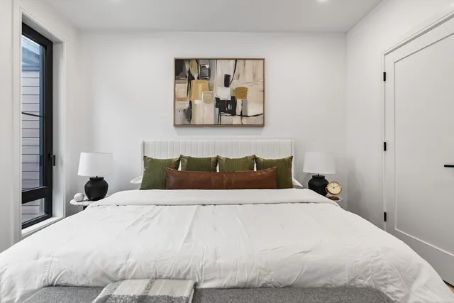 a bedroom with a bed and a painting on the wall