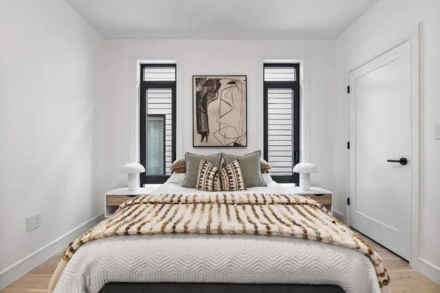 a bedroom with a bed and a window