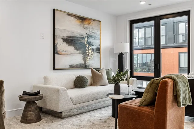 a living room with furniture and large windows