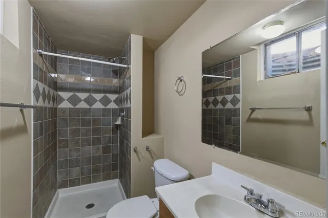 a bathroom with a shower and toilet