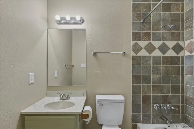 a bathroom with a toilet a sink and a mirror