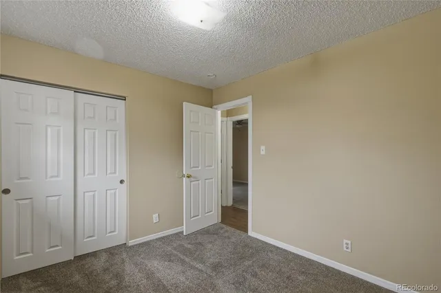 an empty room with closet area