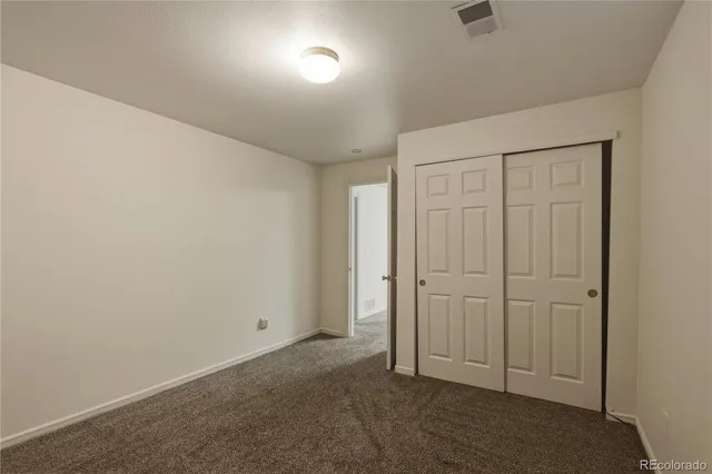 an empty room with closet area