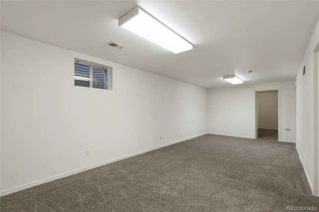 an empty room with a empty space and windows