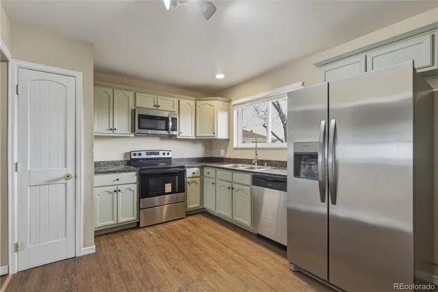 a kitchen with a refrigerator stove and microwave