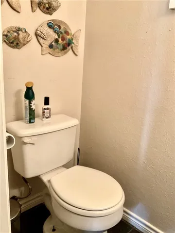 a white toilet sitting next to a white sink
