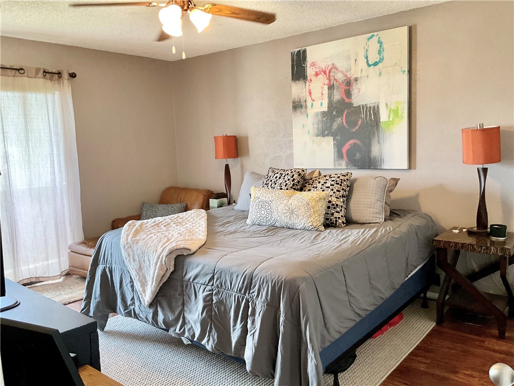 6718 Silvermine Drive, Unit 702 Austin, TX 78736 - Photo 13 of 19 a bedroom with a bed and painting on the wall