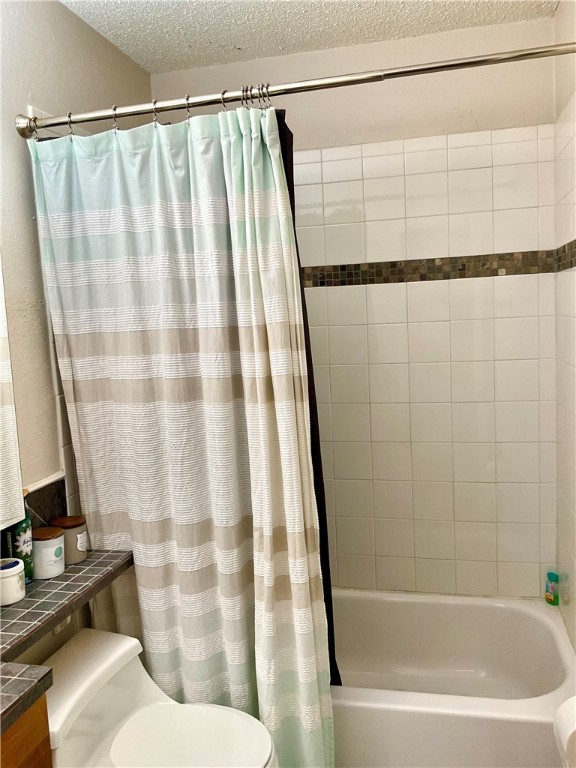 6718 Silvermine Drive, Unit 702 Austin, TX 78736 - Photo 16 of 19 a bathroom with a bathtub and a shower curtain