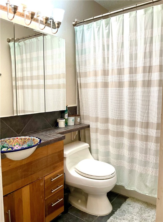 6718 Silvermine Drive, Unit 702 Austin, TX 78736 - Photo 17 of 19 a bathroom with a granite countertop sink a toilet and a bathtub