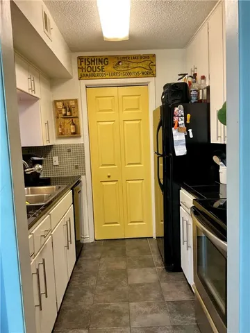 a kitchen with a refrigerator and stove