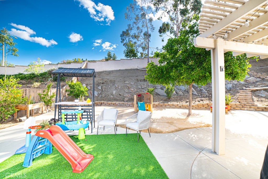 17801 Morning Rock Circle Riverside, CA 92503 - Photo 14 of 18 a view of yard from a patio with a table and chairs