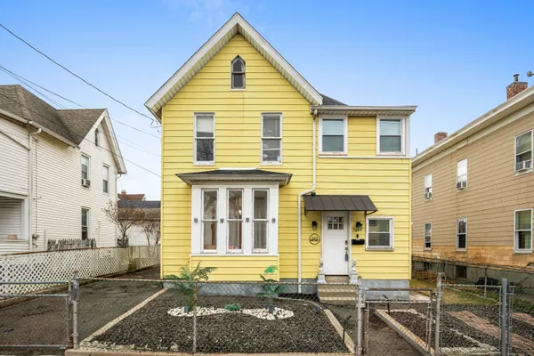 a view of a house with wooden fence