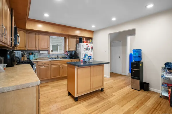 a kitchen with refrigerator and cabinets