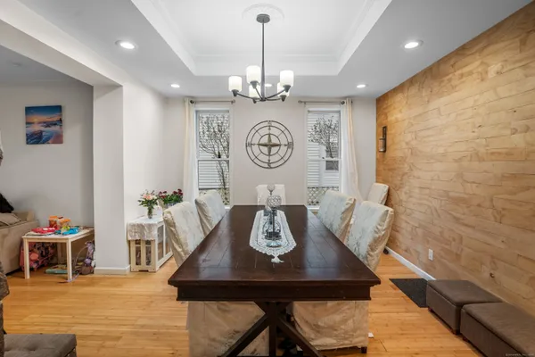 a view of a dining room with furniture and a chandelier