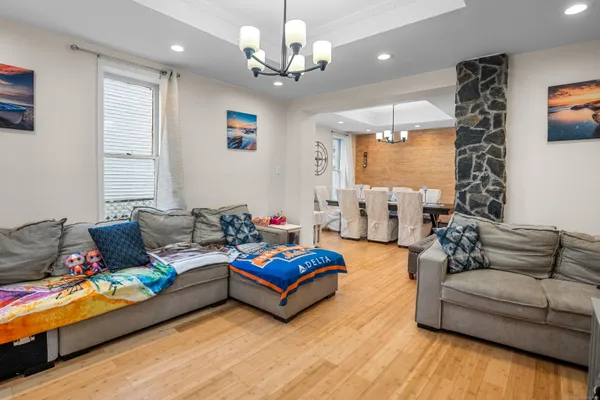 a living room with furniture or couch and a chandelier