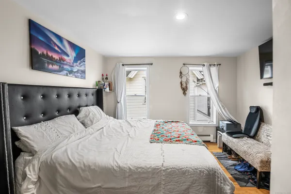 a bedroom with a bed and flat screen tv