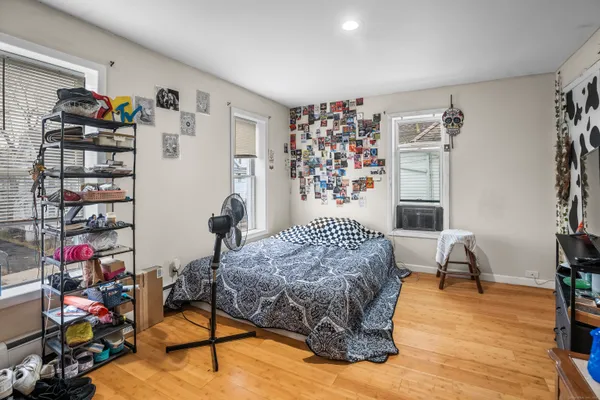 a bedroom with furniture and a book shelf