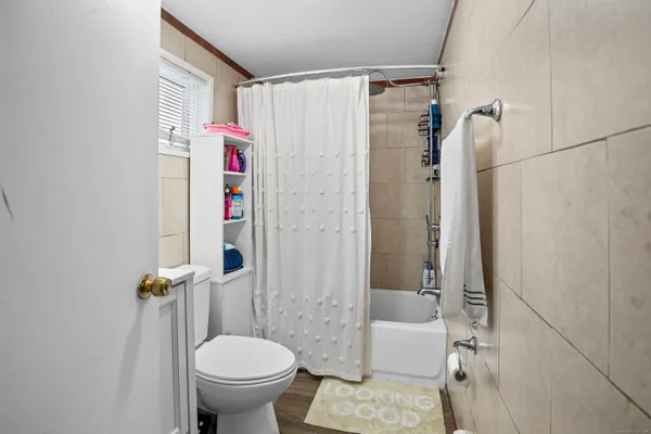 a bathroom with a toilet and a shower