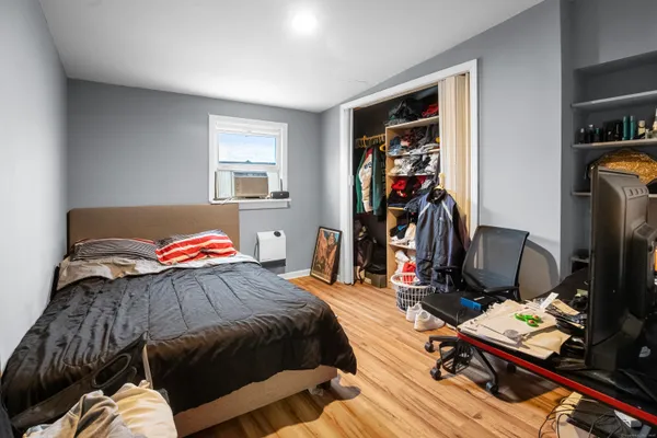 a bedroom with a bed and a window