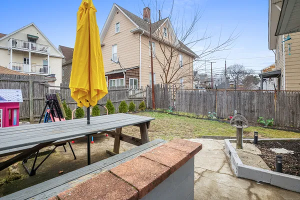 a view of backyard with swimming pool and seating