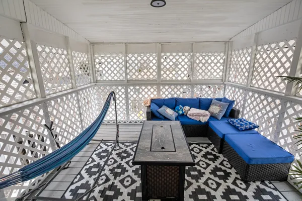 a view of a chairs and table on the deck