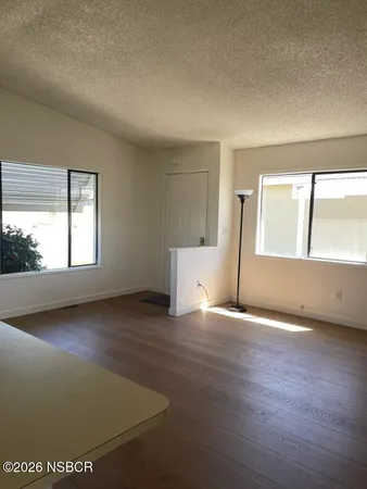 a view of a room with a window and a ceiling fan