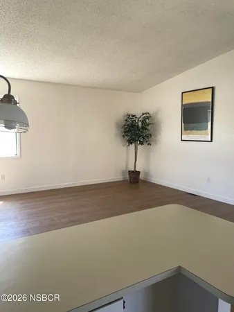 a kitchen with stainless steel appliances granite countertop a sink dishwasher stove top oven and cabinets with wooden floor