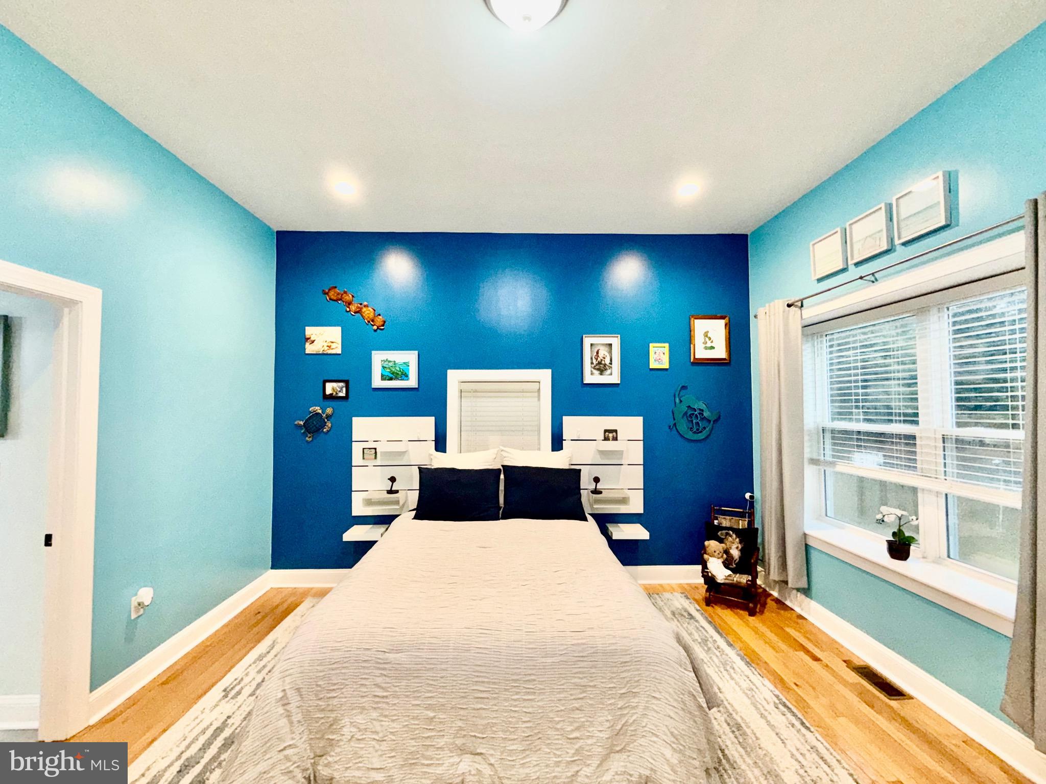 142 Farmington Road West Accokeek, MD 20607 - Photo 33 of 112 a bedroom with a bed and a large mirror with painted walls