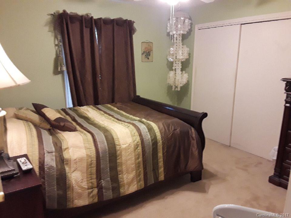 323 North Burris Road Sharon, SC 29742 - Photo 5 of 8 a bed sitting in a bedroom next to a window