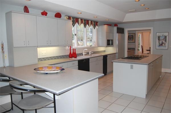 24 Carriage Drive Lexington, MA 02420 - Photo 13 of 30 a kitchen with kitchen island cabinets and window